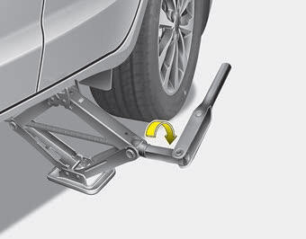 Kia Carnival: Changing tires Kia Carnival: Changing tires. 8.Insert the wheel lug nut wrench into the jack and turn it clockwise, raising